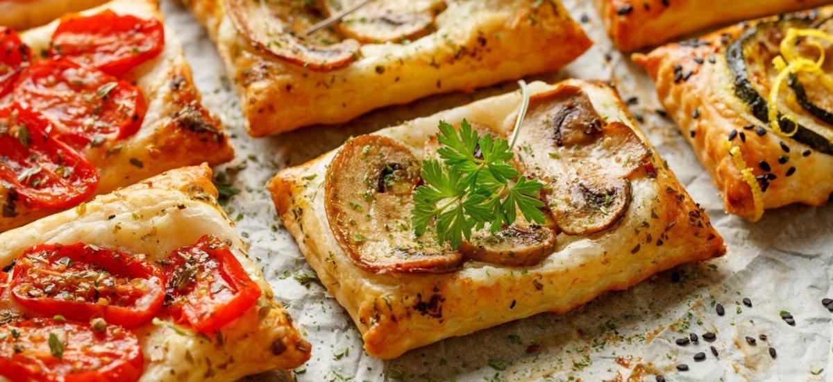 Puff pastry tartlets with cherry tomatoes, feta cheese and olives